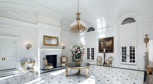 White grand foyer White grand foyer with fireplace and chairs